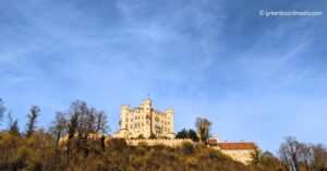 An image of Hohenschwangau castle on top of a hill with blue skies - 3 Weeks in Germany Itinerary