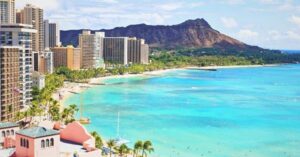 an image of Waikiki Beach coastline featuring tall buildings, blue waters, and the Diamond Head Crater - 3 Weeks in Hawaii Itinerary